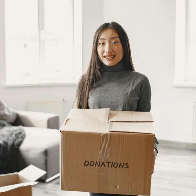 A client holding a box of clothes to be donated