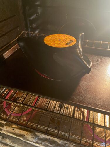 Thrifted vinyl record melting on top of strainer inside oven