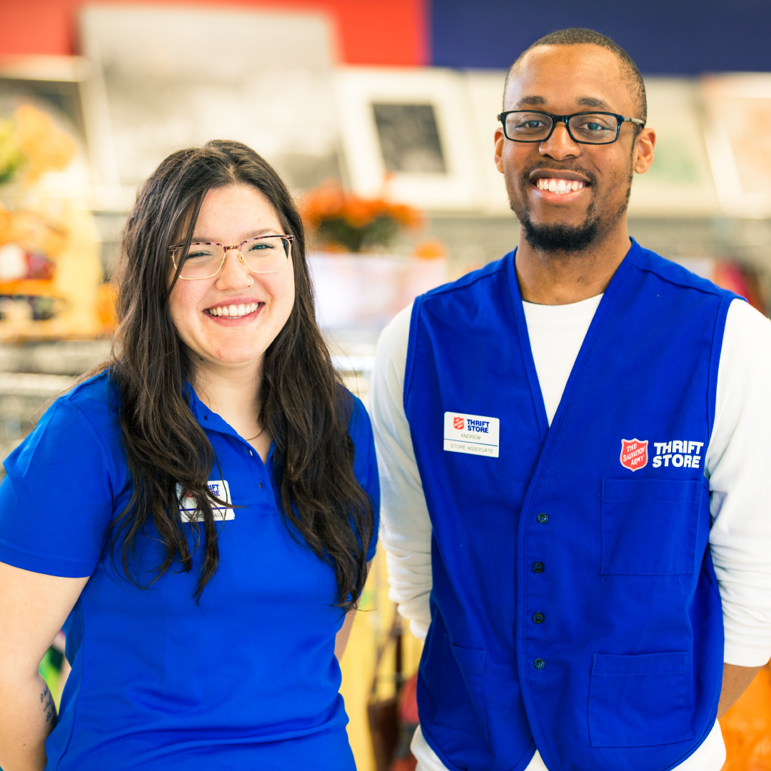 Two Thrift Store employees posing in blue uniforms