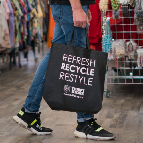 Refresh Recycle Restyle reusable bag being held by person walking