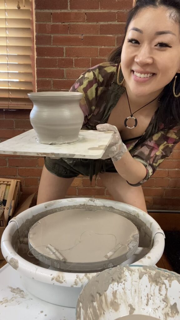 Anna holding finished clay piece