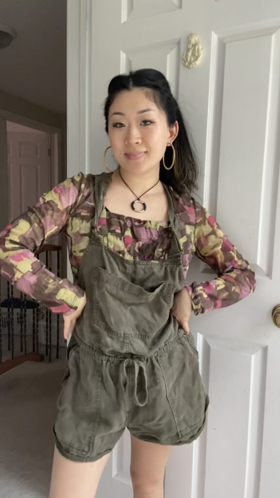 Anna wearing thrifted overalls and long sleeve blouse