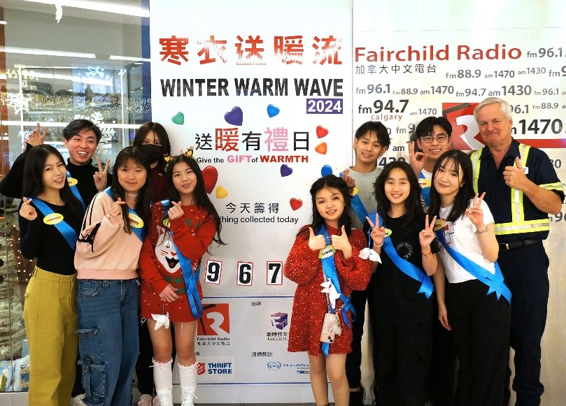 Warm Winter Wave participants standing in front of banner