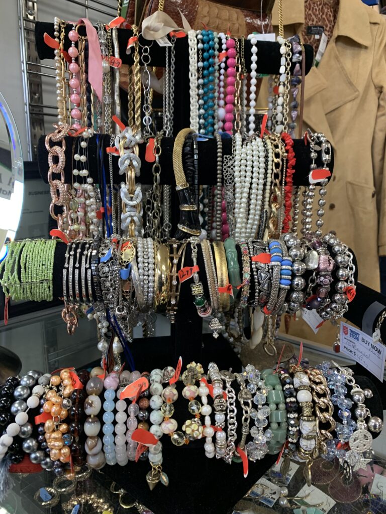 Summer Bracelets hanging on display in Thrift Store