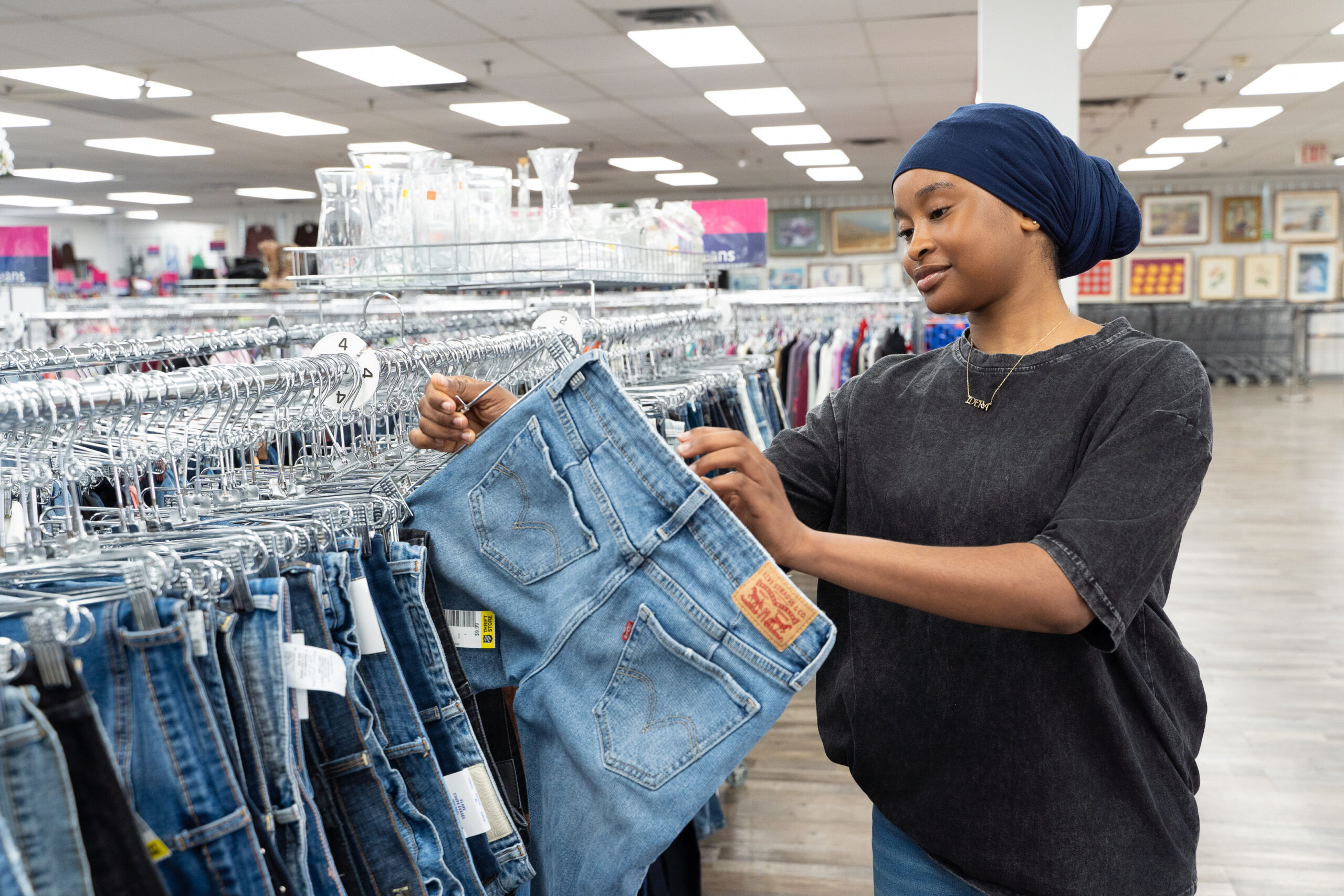 Woman thrifting for jeans