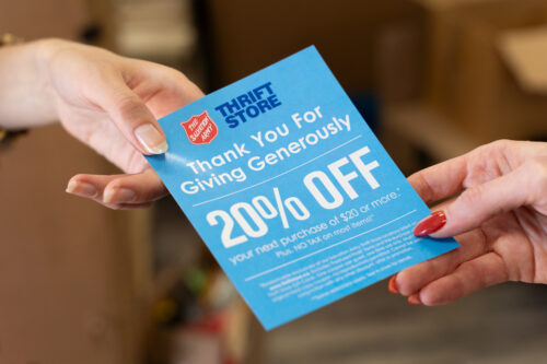 Salvation Army Thrift Store thank-you coupon being handed to donor
