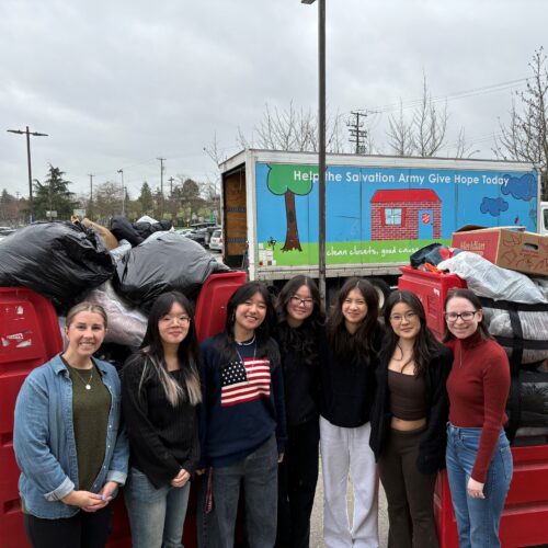 Fashion for Compassion club members posing during clothing donation drive