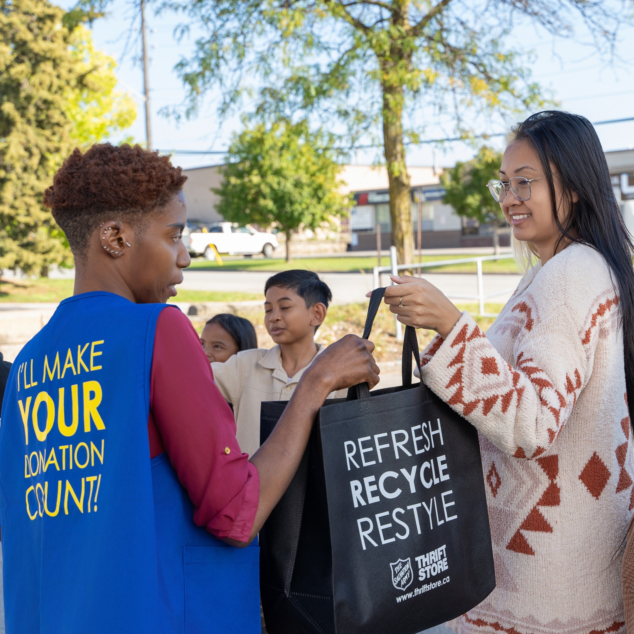 Donations being handed to thrift store employees in bags