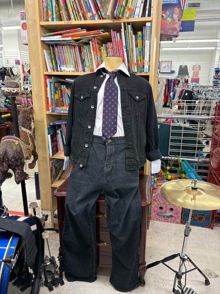 back to school jeans, black long sleeve, tie and white collar on a mannequin