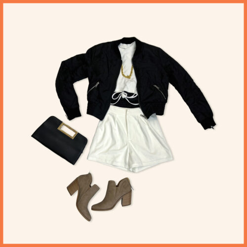 black jacket, white crop top, gold necklace, white shorts, light brown boot heels, and black clutch