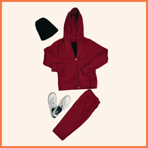 red zip up sweater, red pants, white sneakers, black beanie