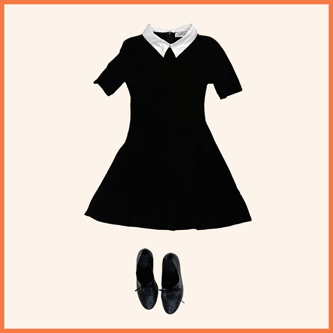 white collar in a black short sleeve dress and black dress shoes
