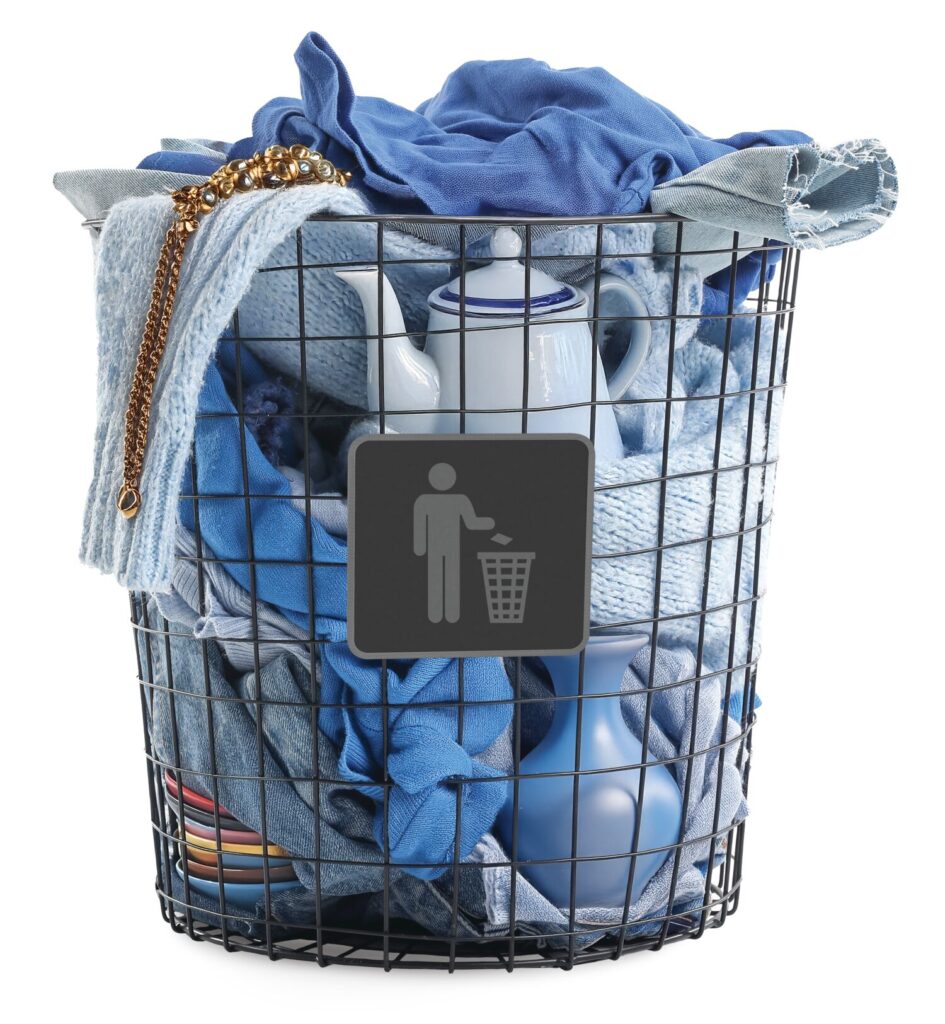 Garbage bin filled with clothing and household items