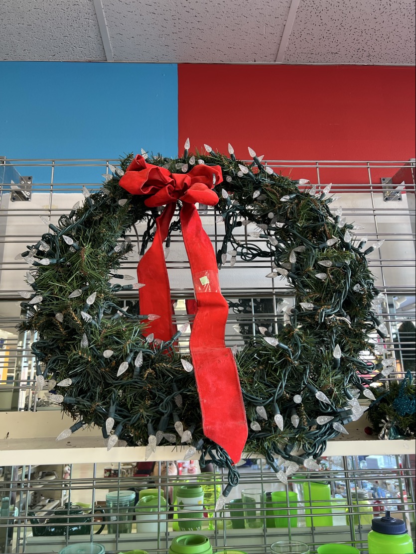 Christmas wreath with holiday lights and red ribbon display