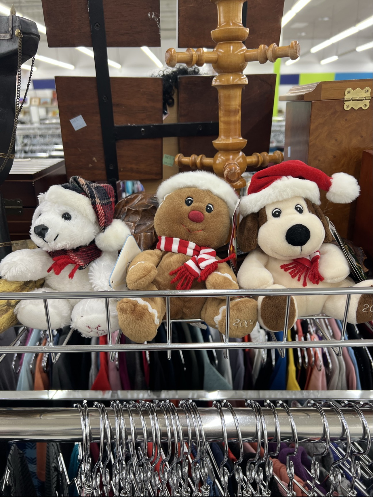 Polar bear plushie wearing a santa hat and scarf, ginerbread man plushie wearing a santa hat and scarf, dog plushie wearing santa hat and scarf