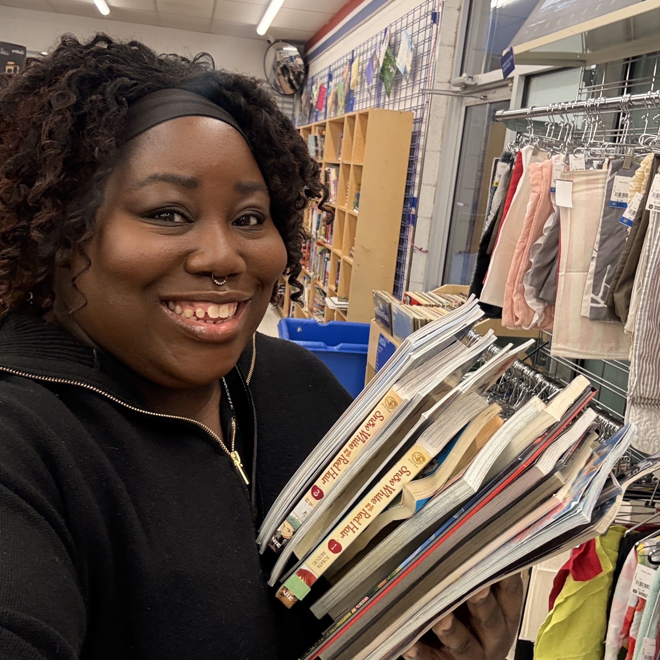 Our collaborator Charmaine smiling with comic books square