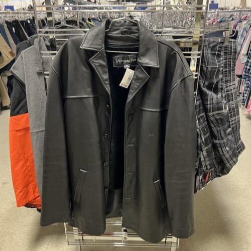 black Men's leather coat hanging on the end of an aisle rack square crop