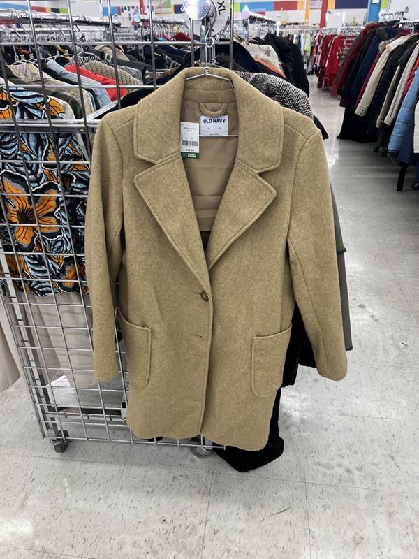 beige trench coat at the end of an aisle rack