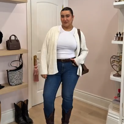 Our collaborator Vanessa in a thrifted outfit wearing jeans, a white t-shirt and a white cardigan