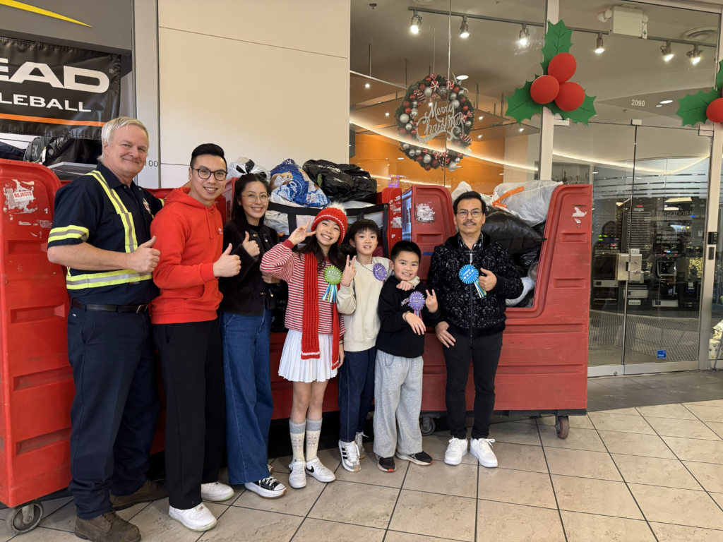 Winter Warm Wave group standing in front of donation bins