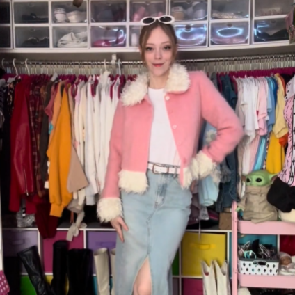 Collaborator Jade in a pink jacket with fuzzy collar and jean skirt