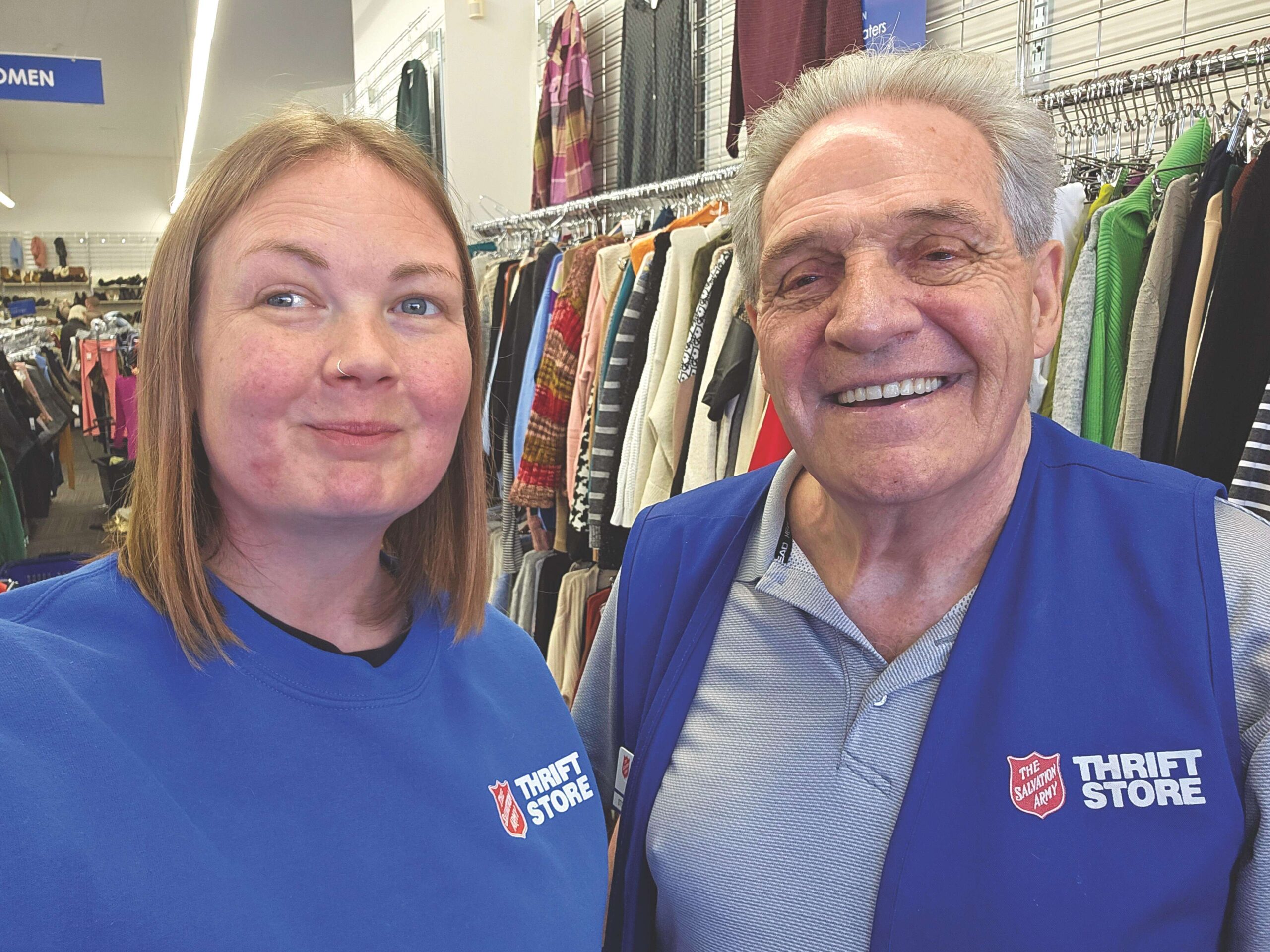 employee Bill Lewis smiling beside female coworker