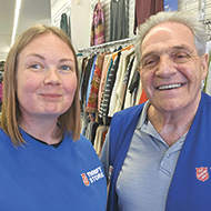 employee Bill Lewis smiling beside female coworker