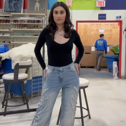 Our collaborator Camille trying on a pair of jeans in the thrift store